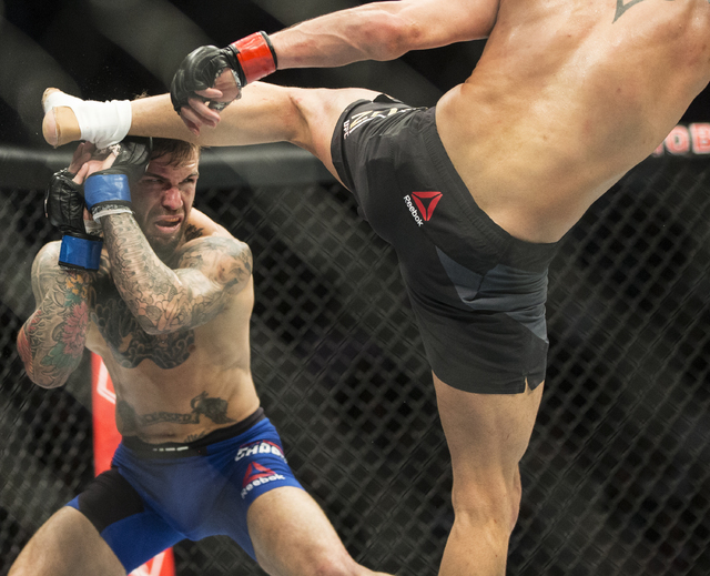 Cody Garbrandt, left, blocks a kick from Dominick Cruz during their bantamweight fight at UFC 207 at T-Mobile Arena on Friday, Dec. 30, 2016, in Las Vegas. Benjamin Hager/Las Vegas Review-Journal