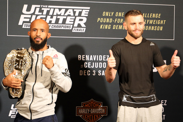 UFC flyweight champion Demetrious Johnson (left) hoists his belt over his shoulder after squaring off with Tim Elliott ahead of their The Ultimate Fighter 24 Finale bout at The Palms in Las Vegas. ...