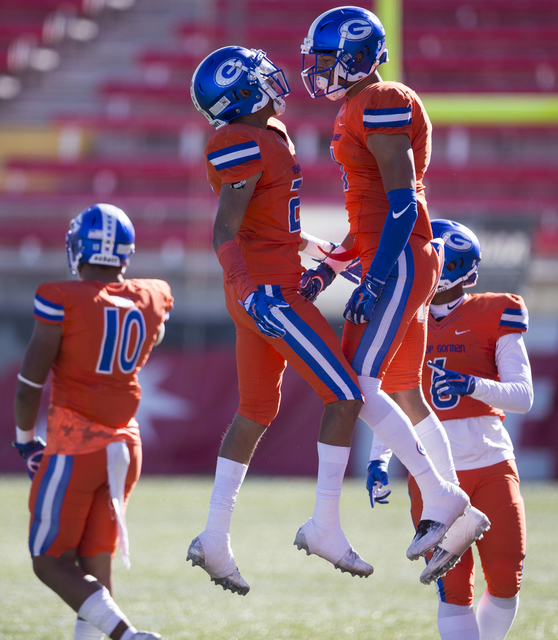 Bishop Gorman Pierson Mook (20), left, celebrates his interception with Damuzhea Bolden in the Class 4A state football championship game at Sam Boyd Stadium on Saturday, Dec. 3, 2016, in Las Vegas ...
