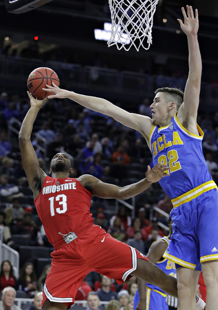 Ohio State's JaQuan Lyle (13) shoots around UCLA's TJ Leaf during the second half of an NCAA college basketball game Saturday, Dec. 17, 2016, in Las Vegas. UCLA won 86-73. (John Locher/AP)