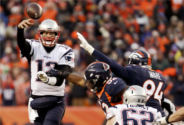New England Patriots quarterback Tom Brady passes under pressure against the Denver Broncos during the second half Sunday, Dec. 18, 2016, in Denver. (AP Photo/Jack Dempsey)