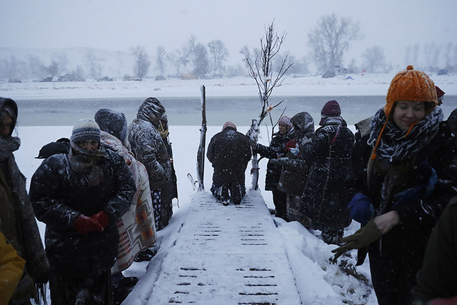 People pray along the Cannonball River during a Native American water ceremony at the Oceti Sakowin camp where people have gathered to protest the Dakota Access oil pipeline in Cannon Ball, North ...