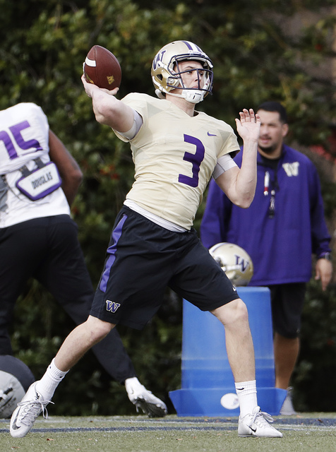 Washington quarterback Jake Browning throws a pass during a Peach Bowl NCAA college football practice in Atlanta, Wednesday, Dec. 28, 2016. Alabama and Washington will face off in the Peach Bowl f ...
