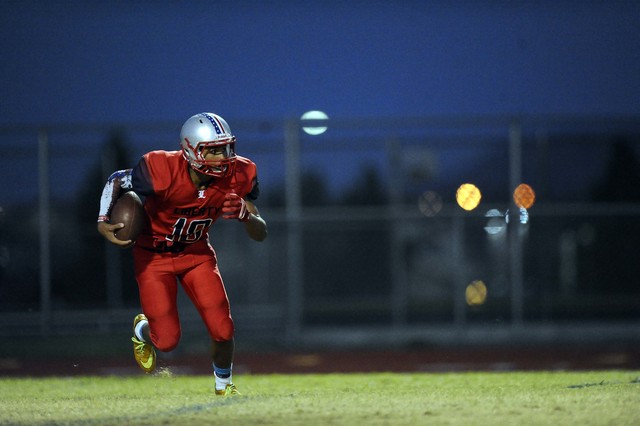 Liberty Patriots punter/defensive end Damahny Whittle runs for a first down on a fake punt attempt against the Coronado Cougars in the first quarter of a high school football game at Liberty High ...