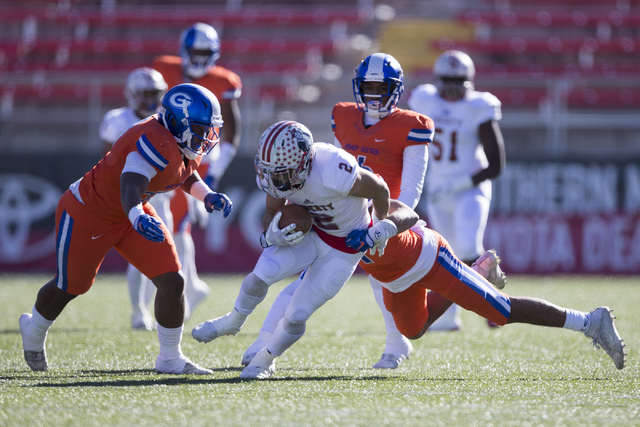 Liberty's Ethan Dedeaux (2) is tackled by Bishop Gorman after a catch in the Class 4A state football championship game at Sam Boyd Stadium on Saturday, Dec. 3, 2016, in Las Vegas. Bishop Gorman wo ...