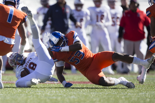 Liberty's Bryson Dela Cruz (8) is tackled by Bishop Gorman's Farrell Hester (53) after a run in the Class 4A state football championship game at Sam Boyd Stadium on Saturday, Dec. 3, 2016, in Las  ...