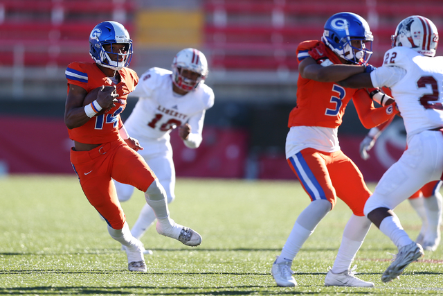 Bishop Gorman's Dorian Thompson-Robinson (14) runs the ball against Liberty in the Class 4A state football championship game at Sam Boyd Stadium on Saturday, Dec. 3, 2016, in Las Vegas. Bishop Gor ...