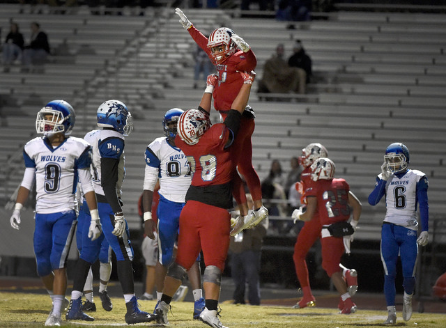Liberty's Darion Acohido is raised by teammate Will Brewer (78) after Acohido score a touchdown against Basic during a high school football game at Liberty High School Friday, Nov. 18, 2016, in He ...