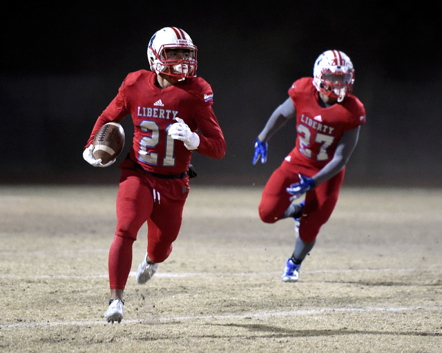 Liberty's Darion Acohido (21) runs against Basic during the second half of a high school football game at Liberty High School Friday, Nov. 18, 2016, in Henderson. Liberty won 58-14. (David Becker/ ...