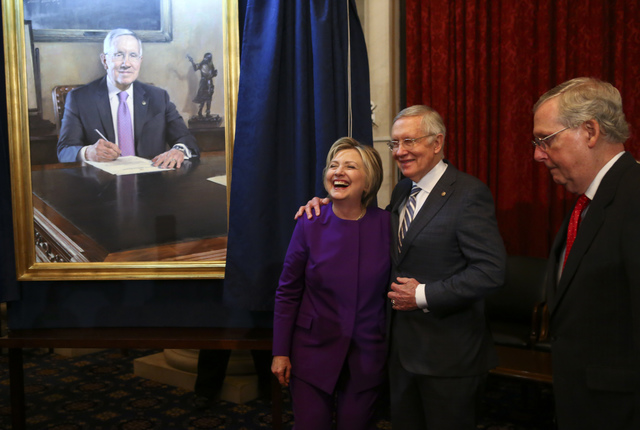 Senate Minority Leader Harry Reid, D-Nev., center, shares a laugh with former Secretary of State Hillary Clinton during a ceremony to unveil a portrait of Reid on Capitol Hill in Washington D.C. o ...