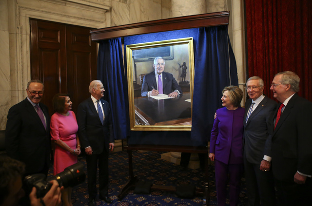 Government officials take part in a ceremony to unveil a portrait of Senate Minority Leader Harry Reid, D-Nev., second from right, on Capitol Hill in Washington D.C. on Thursday, Dec. 8, 2016. (Ch ...