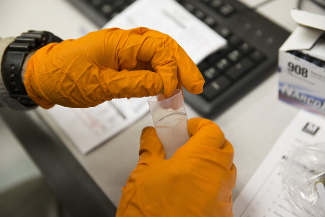 Las Vegas police officer Manuel Papazian uses a drug test kit to confirm for marijuana at the Las Vegas Metropolitan Police Department Downtown Area Command on Saturday, Oct. 8, 2016, in Las Vegas ...