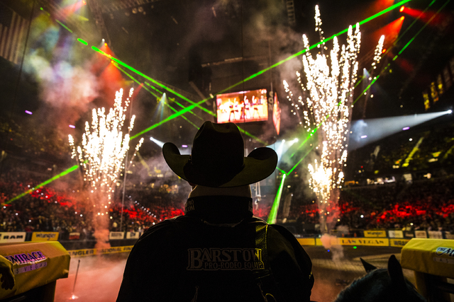 Bareback rider Jesse Davis watches opening ceremonies during the ninth day of the National Finals Rodeo at the Thomas & Mack Center on Friday, Dec. 9, 2016, in Las Vegas. Benjamin Hager/Las Ve ...