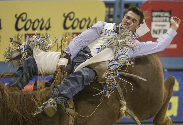 Caleb Bennett rides Pass the Hat during the bareback riding competition during the ninth day of the National Finals Rodeo at the Thomas & Mack Center on Friday, Dec. 9, 2016, in Las Vegas. Ben ...