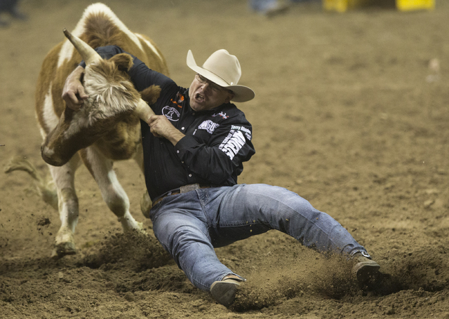 Matt Reeves competes in the steer wrestling competition on the ninth day of the National Finals Rodeo at the Thomas & Mack Center on Friday, Dec. 9, 2016, in Las Vegas. Benjamin Hager/Las Vega ...