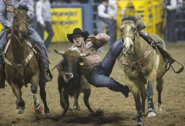 Nick Guy competes in the steer wrestling competition on the ninth day of the National Finals Rodeo at the Thomas & Mack Center on Friday, Dec. 9, 2016, in Las Vegas. Benjamin Hager/Las Vegas R ...