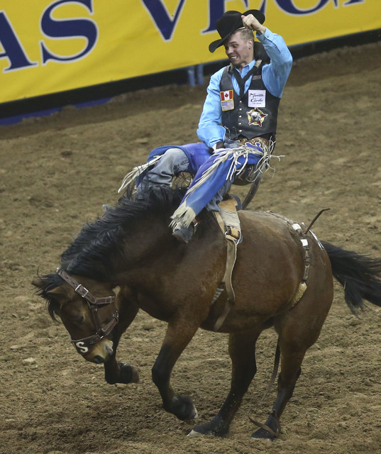 Orin Larsen rides What Happens while competing in the bareback riding event during the 2nd go-round of the National Finals Rodeo at the Thomas & Mack Center in Las Vegas on Friday, Dec. 2, 201 ...