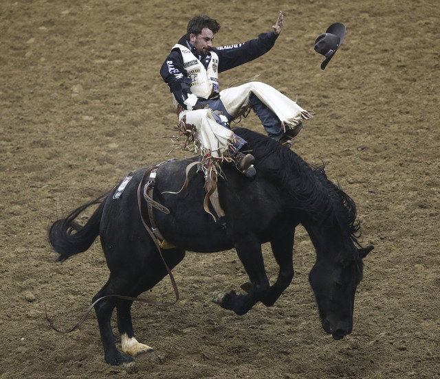 Winn Ratliff rides Black Kat while competing in the bareback riding event during the 2nd go-round of the National Finals Rodeo at the Thomas & Mack Center in Las Vegas on Friday, Dec. 2, 2016. ...