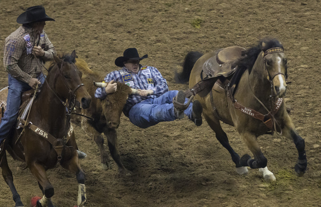 Nick Guy competes during the steer wrestling competition on the final night of the National Finals Rodeo at the Thomas & Mack Center in Las Vegas on Saturday, Dec. 9, 2016. (Miranda Alam/Las V ...