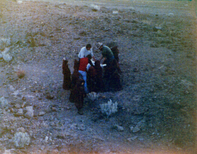 Film crew members and costumed school children huddle around R2-D2 during filming of the original &quot;Star Wars&quot; move in Death Valley in January 1977. (Sally Weber)