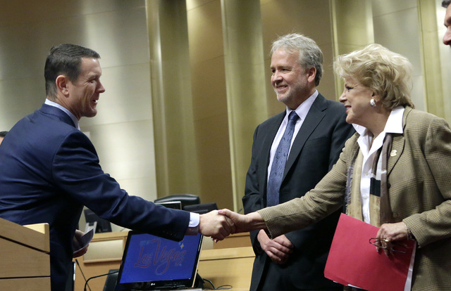 Pat Egan, NV Energy senior vice president of customer operations, left, shakes hands with Mayor Carolyn Goodman, as Tom Perrigo, planning director and chief sustainability officer at City of Las V ...