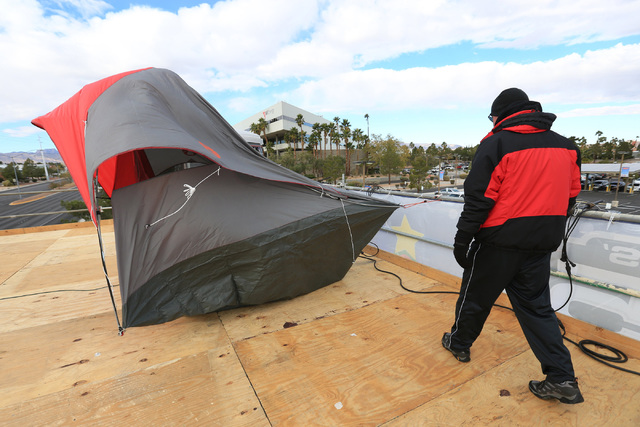 Chet Buchanan, host of 98.5 KLUC's Chet Buchanan and the Morning Zoo, adjusts his tent on a 20-foot tall scaffolding where he will spend 12 days pushing the 18th annual KLUC Toy Drive on Friday, D ...
