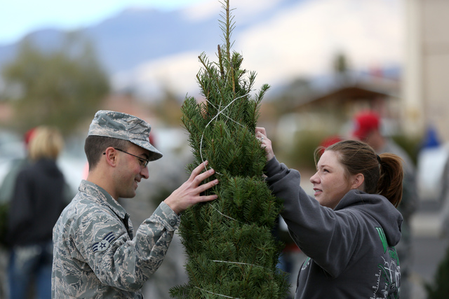 Senior Airman Adam Low and wife Bethany decide on a Christmas tree  during the annual Christmas SPIRIT Foundation’s Trees for Troops Program at Nellis Air Force Base on Friday, December 2,  ...