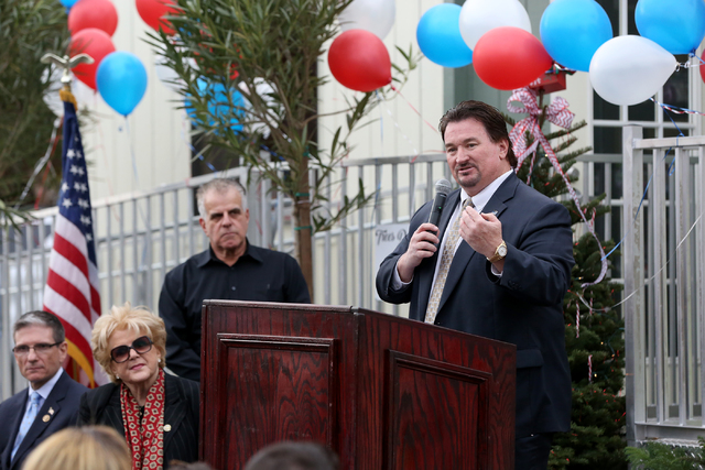 During the grand opening and ribbon cutting ceremony for the second Veterans Village, Nevada Republican Party Chairman Michael McDonald, right, addresses a crowd that includes Rep. Joe Heck, far l ...