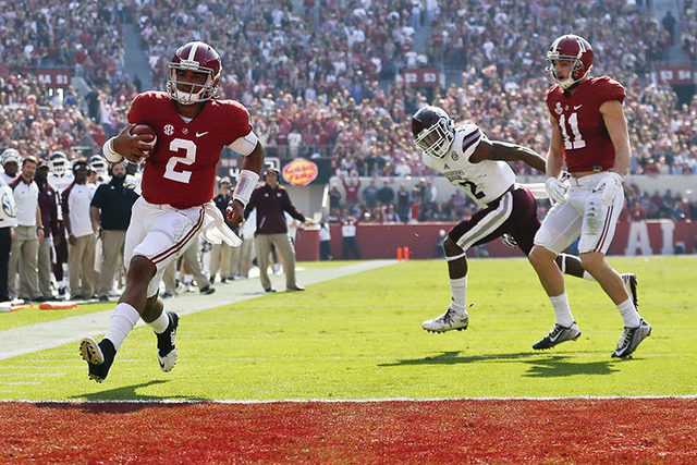 Alabama quarterback Jalen Hurts, left, scores a touchdown during the first half of an NCAA college football game against Mississippi State, Saturday, Nov. 12, 2016, in Tuscaloosa, Ala. (AP Photo/B ...