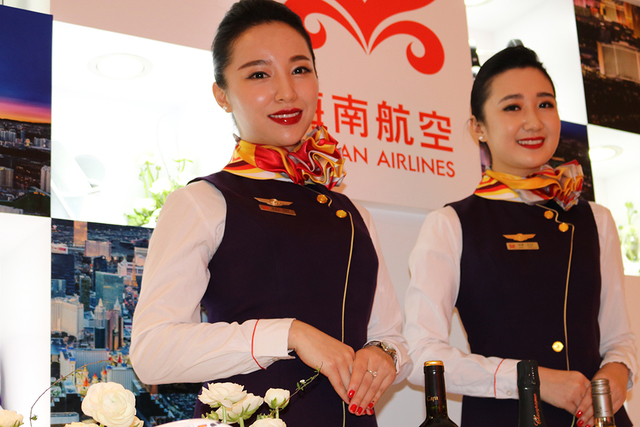 Hainan Airlines flight attendants Ashley Fan (left) and April Lu welcome guests at a launch party for Hainan Airlines' nonstop service from Beijing to Las Vegas. Hainan Airlines and the LVCVA host ...