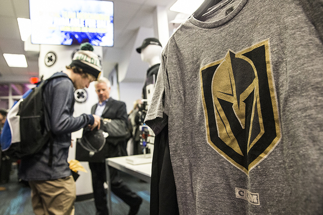 Fans purchase official Golden Knights merchandise at the conclusion of a ceremony to unveil the Las Vegas' NHL expansion franchise's official team nickname, logos and colors on Tuesday, Nov. 22, 2 ...