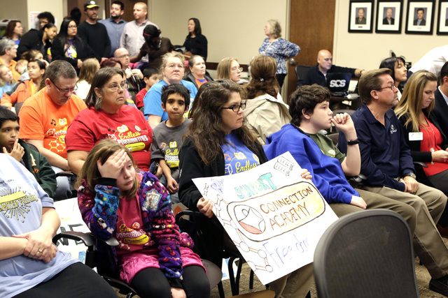 Parents and students supporting the online Nevada Connections Academy charter school, including Carly Held, center, and her son Nathan, 14, attend a public hearing on Friday, Dec. 16, 2016, at the ...