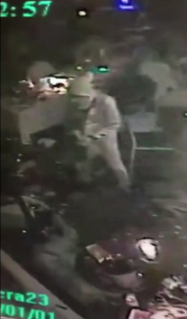 An attacker carrying a gun walks in the nightclub in Istanbul, early Sunday, Jan. 1, 2017. An assailant opened fire at a crowded nightclub in Istanbul during New Year's celebrations, killing dozen ...