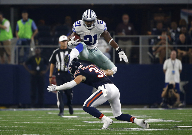 In this Sept. 25, 2016, file photo, Dallas Cowboys running back Ezekiel Elliott (21) leaps over a tackle attempt by Chicago Bears' Chris Prosinski (31) in the second half of an NFL football game, ...