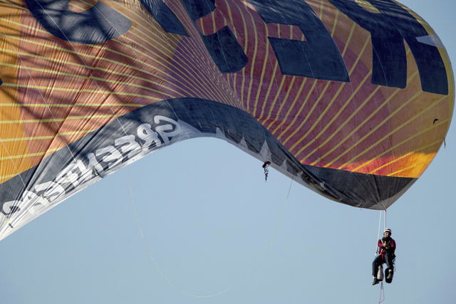Greenpeace protesters unfurl a banner that reads "Resist" at the scene at the construction site of the former Washington Post building in Washington, Wednesday, Jan. 25, 2017, after police say pro ...