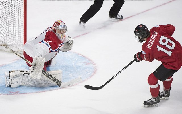 Switzerland's Nico Hischier (18) scores on Czech Republic's goaltender Jakub Skarek during the overtime period inpreliminary round IIHF World Junior Championship hockey action in Montreal, Tuesday ...