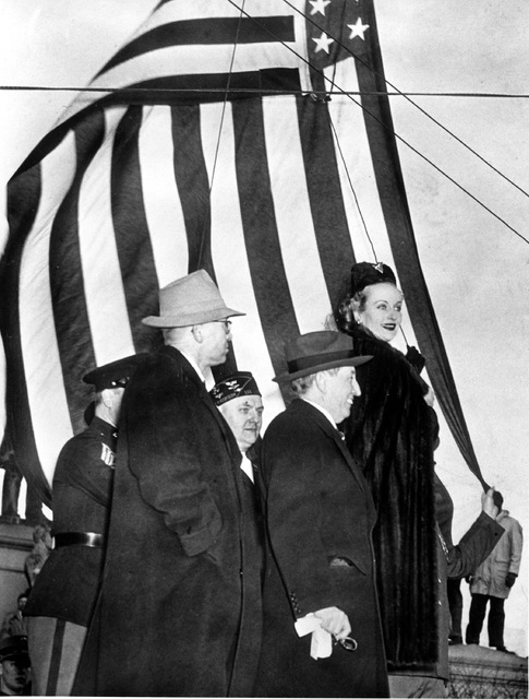 Actress Carole Lombard, right, is seen with Motion Picture Producers and Distributors of America Will Hays, center, and Indiana Defense Savings chairman Eugene D. Pulliam, left, as they opened a d ...