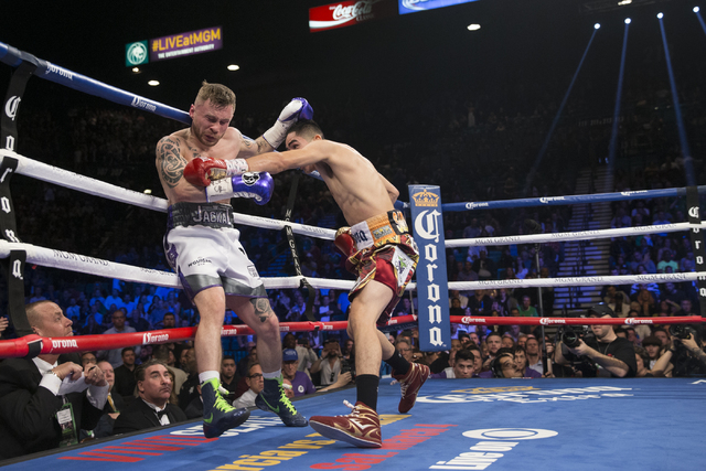 Leo Santa Cruz, right, connects a punch against Carl Frampton in the WBA Featherweight Championship bout at MGM Grand Garden Arena on Saturday, Jan. 28, 2017, in Las Vegas. Santa Cruz won by split ...