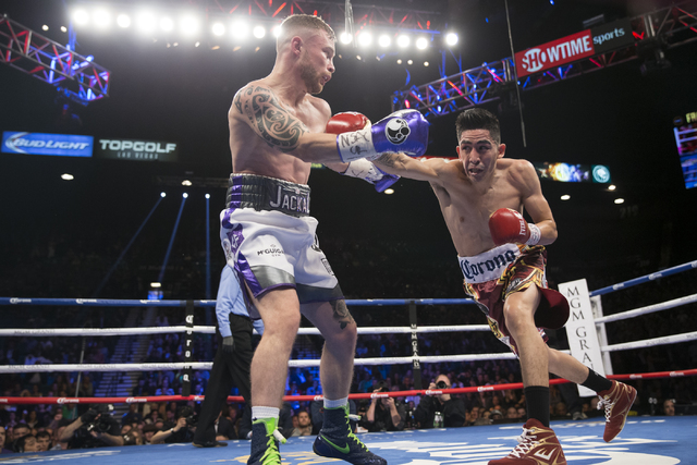 Carl Frampton, left, battles Leo Santa Cruz in the WBA Featherweight Championship bout at MGM Grand Garden Arena on Saturday, Jan. 28, 2017, in Las Vegas. Santa Cruz won by split decision. (Erik V ...
