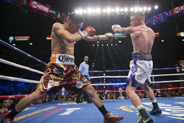 Leo Santa Cruz, left, battles Carl Frampton in the WBA Featherweight Championship bout at MGM Grand Garden Arena on Saturday, Jan. 28, 2017, in Las Vegas. Santa Cruz won by split decision. (Erik V ...