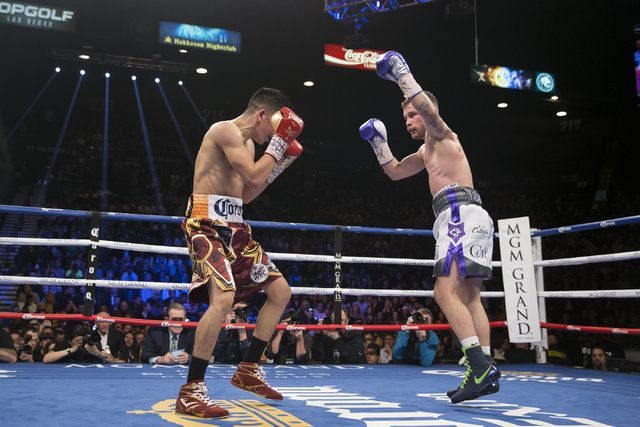 Leo Santa Cruz, left, battles Carl Frampton in the WBA Featherweight Championship bout at MGM Grand Garden Arena on Saturday, Jan. 28, 2017, in Las Vegas. Santa Cruz won by split decision. (Erik V ...
