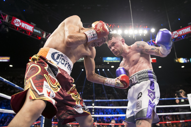 Leo Santa Cruz, left, battles Carl Frampton in the WBA Featherweight Championship bout at MGM Grand Garden Arena on Saturday, Jan. 28, 2017, in Las Vegas. Santa Cruz won by split decision. (Erik V ...