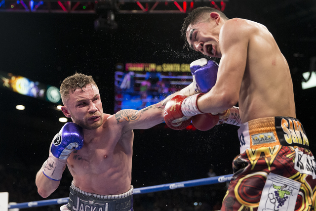 Carl Frampton, left, connects a punch against Leo Santa Cruz in the WBA Featherweight Championship bout at MGM Grand Garden Arena on Saturday, Jan. 28, 2017, in Las Vegas. Santa Cruz won by split ...