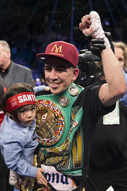 Leo Santa Cruz, holding his son Alan, 2, celebrates his split decision win against Carl Frampton in the WBA Featherweight Championship bout at MGM Grand Garden Arena on Saturday, Jan. 28, 2017, in ...