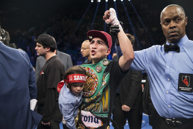 Leo Santa Cruz, holding his son Alan, 2, celebrates his split decision win against Carl Frampton in the WBA Featherweight Championship bout at MGM Grand Garden Arena on Saturday, Jan. 28, 2017, in ...