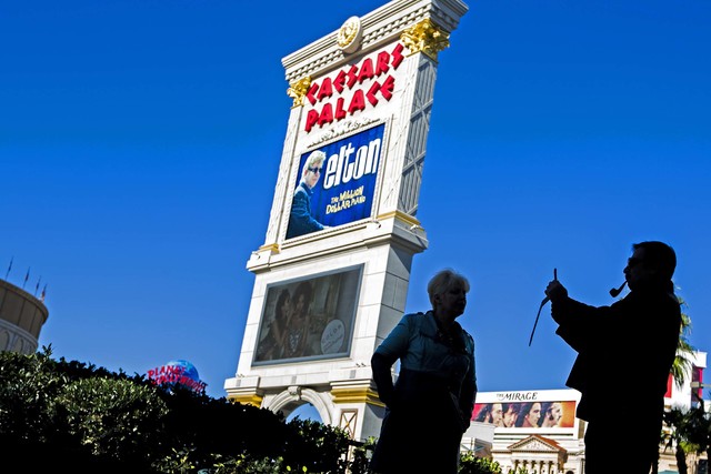 A man take a photo across the street from Caesars Palace in Las Vegas. (Jeff Scheid/Las Vegas Review-Journal)