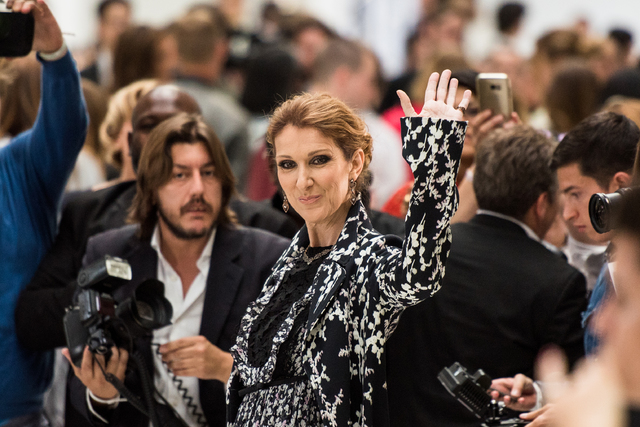 Celine Dion waves at photographers before Giambattista Valli's fall-winter 2016-2017 haute-couture fashion collection presented in Paris, France, in 2016. (Zacharie Scheurer/Associated Press)