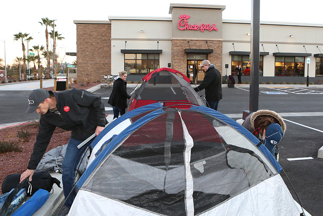 Taylor Ball, left, his wife, Janae, right, and Kirk Philips and his wife, Samantha, center, set up their tents outside Chick-fil-A at 9925 S. Eastern Ave. in Henderson Wednesday, Jan. 25, 2017. (B ...