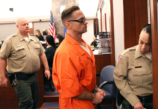 Two-time killer Scott Dozier leaves the courtroom after his hearing at the Regional Justice Center on Thursday, Jan. 19, 2017, in Las Vegas. Dozier, who is on death row, is asking a judge to force ...