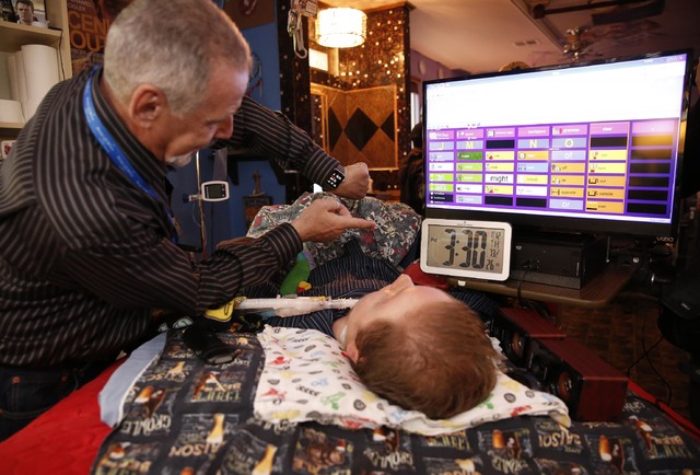 Make-A-Wish Southern Nevada volunteer Dave Revzin shows Cashel Gardner his watch at the Gardner family home, Thursday, Jan. 12, 2017, in Las Vegas. Make-A-Wish Southern Nevada and its partners for ...
